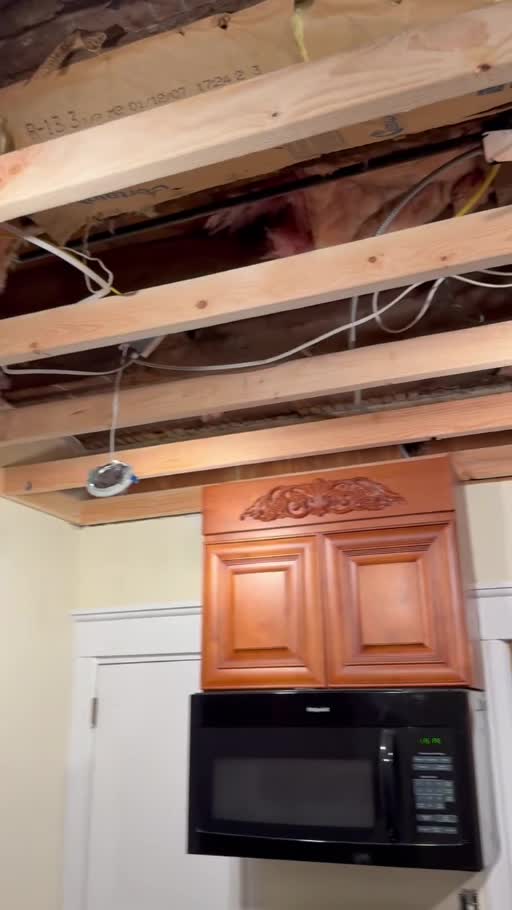 Kitchen ceiling before repair, with exposed framing
