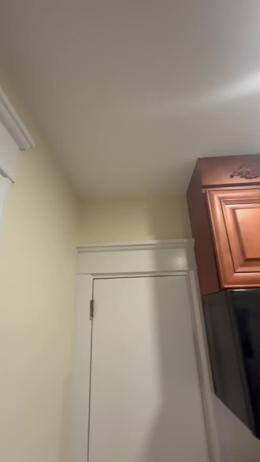 The same kitchen with a finished white ceiling